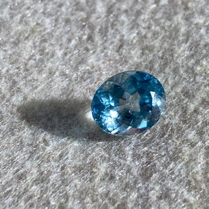 Oval-shaped loose blue topaz gemstone