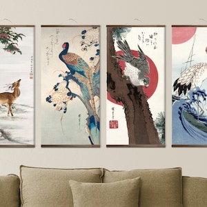 May include: Four Japanese-style scroll paintings depicting a deer, a peacock, a hawk, and a crane. The scrolls are mounted on wooden dowels and have a light brown background.