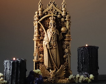 May include: A golden statue of Death, holding a scythe and standing in a gothic archway, with two black candles on either side.