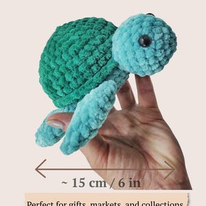 May include: A crocheted turtle plush toy with a dark green shell and light blue head and flippers. The turtle features black plastic eyes. A horizontal arrow indicates a finished size of approximately 6 inches. Text reads FINISHED SIZE.
