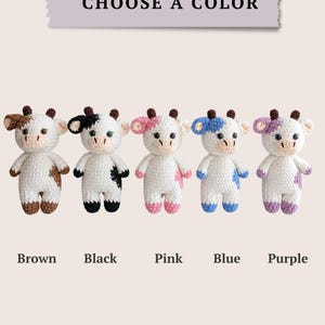 Five color options of crochet cow plush toys: brown, black, pink, blue and purple.