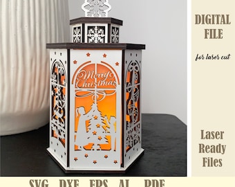 May include: A white wooden Christmas lantern with a cutout design of a Christmas tree, two children, and the words "Merry Christmas". The lantern has a warm orange glow coming from inside.