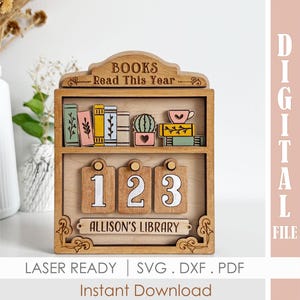 May include: A wooden bookshelf-style display with the text "BOOKS Read This Year." It features decorative miniature books, a cactus, and a teacup. Below are wooden number tags and the text "ALLISON'S LIBRARY." The bottom text reads "LASER READY | SVG .DXF .PDF Instant Download."