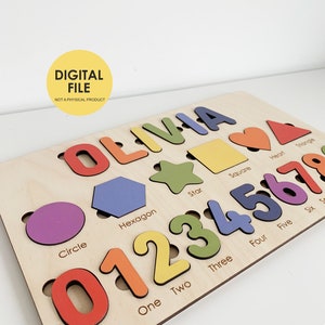 May include: Wooden educational puzzle with the name "OLIVIA" in colourful letters, shapes, and numbers 0-7. Includes a circle, hexagon, star, square, heart, and triangle. The text "DIGITAL FILE NOT A PHYSICAL PRODUCT" is also present.