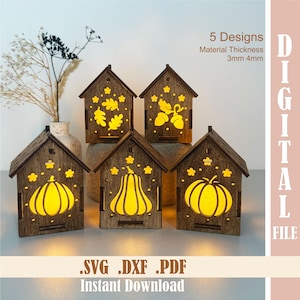 May include: Five wooden house-shaped lanterns with cut-out designs of pumpkins, acorns, and leaves. The lanterns are illuminated from within, creating a warm glow. The text on the image says "5 Designs" and "Instant Download".