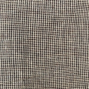 May include: Close-up of a brown fabric with a white and black houndstooth pattern.