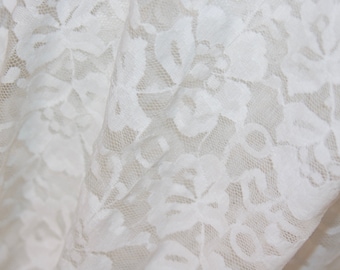 May include: White lace fabric with a floral pattern.