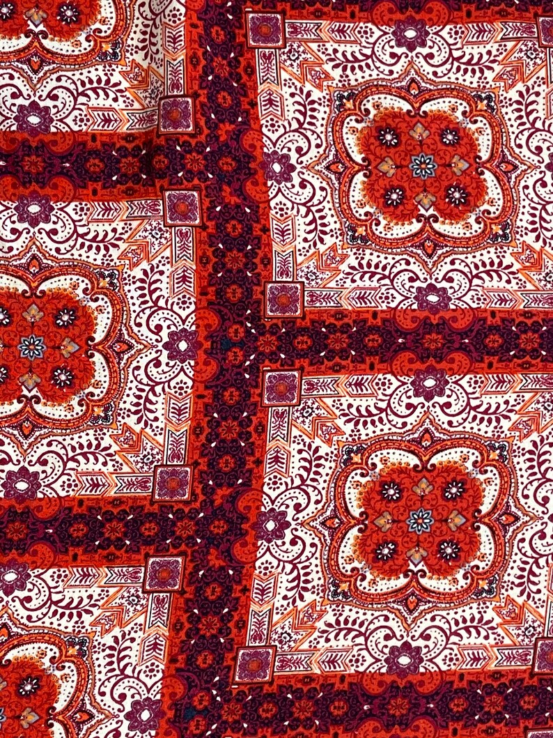 K&ouml;nnte beinhalten: Roter, wei&szlig;er und brauner Stoff mit Paisley-Muster. Der Stoff hat ein sich wiederholendes Muster aus Quadraten mit komplizierten Details.