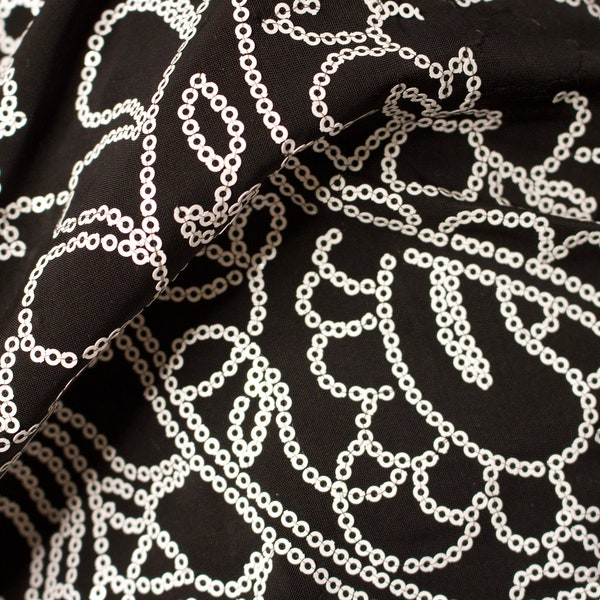 Black Spandex with white sequins, sold by the YARD