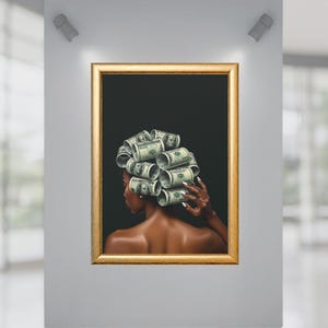 May include: A framed artwork featuring a woman with her hair styled in dollar bill curlers. The portrait is set against a black background, with a gold-colored frame. The woman's skin is dark, and she is viewed from the back.