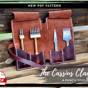 May include: A brown leather pouch with white stitching detail, containing a set of leather working tools. The pouch has a strap and is labelled "The Cassius Clay A PUNCH TOOLKIT".
