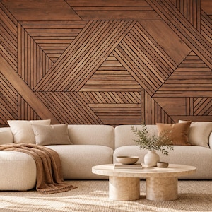 May include: A large, cream-colored sectional sofa with a chaise lounge, featuring a textured fabric. A round, light-colored stone coffee table sits in front, topped with a small vase and bowl. A brown throw blanket rests on the sofa.