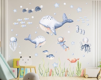 May include: A set of blue and white watercolor-style ocean animal wall decals. The decals include a whale, a jellyfish, a turtle, a starfish, a crab, a seahorse, an octopus, and a diver. The decals are perfect for adding a touch of whimsy to a child's room.