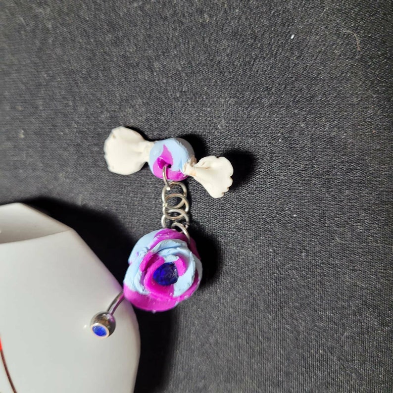 Blue and violet rose belly barbell with wrapped candy dangle