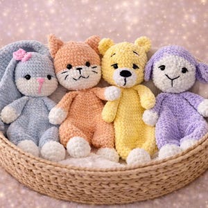 May include: A collection of four handmade crochet stuffed animals in a woven basket. The animals include a blue bunny, an orange cat, a yellow bear, and a purple lamb. Each has white accents and a unique facial expression.