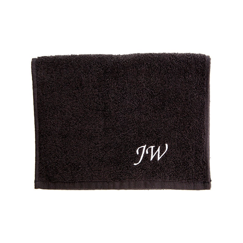 May include: A black towel with the initials "JW" embroidered in white.