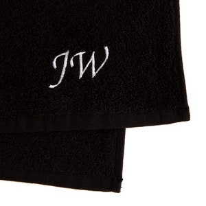 May include: Black towel with white embroidered initials "JW"
