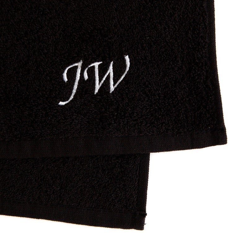 May include: Black towel with white embroidered initials "JW"