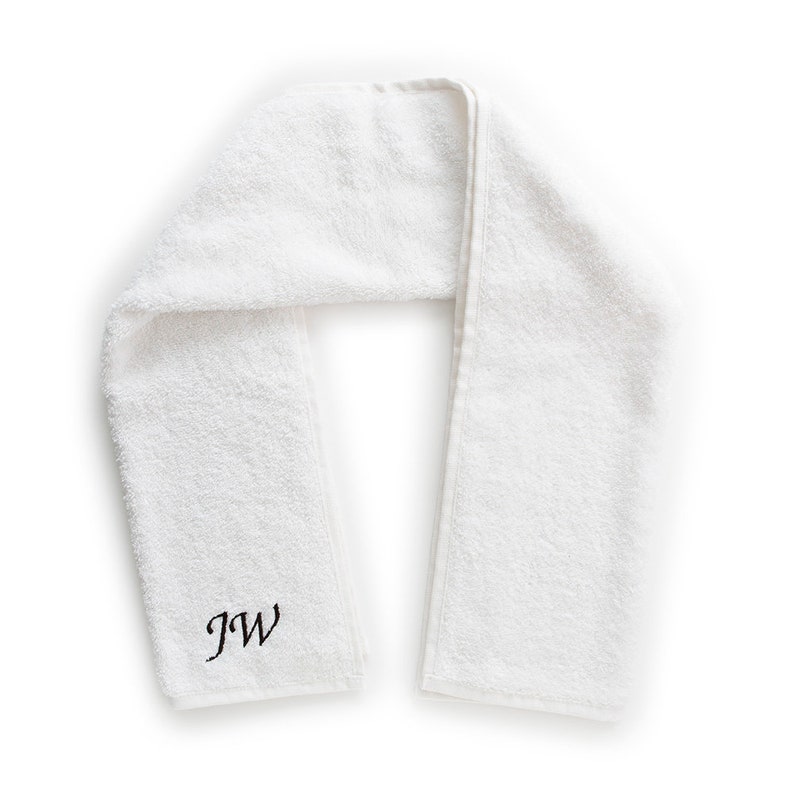 May include: White towel with the initials "JW" embroidered in black.