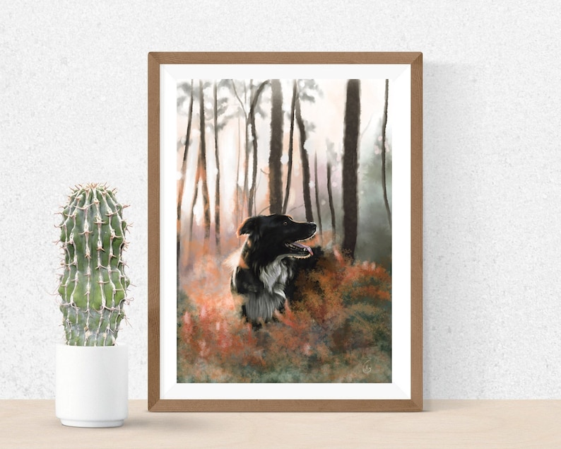 May include: A framed print depicting a black and white dog in a woodland scene. The dog is positioned amidst trees and autumnal undergrowth. The artwork is presented in a wooden frame, with a cactus in a white pot in the foreground, adding a touch of nature.