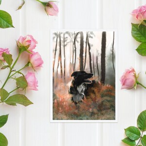 May include: An art print depicting a black and white dog in a forest scene. The dog is central, set against a backdrop of tall trees and autumnal foliage. Pink roses and green leaves are arranged around the print on a white surface.