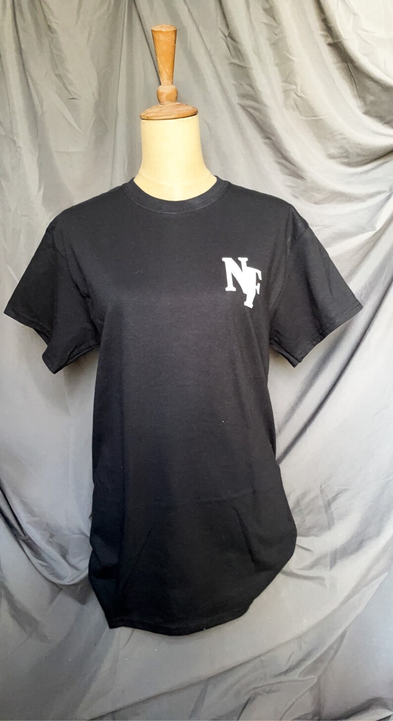 K&ouml;nnte beinhalten: Schwarzes T-Shirt mit einem wei&szlig;en "NF"-Logo auf der Vorderseite.