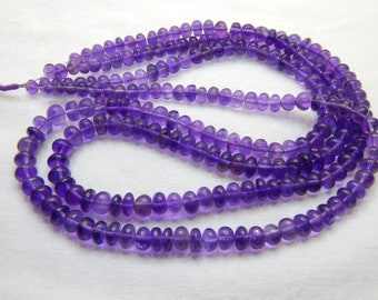 May include: A strand of amethyst beads, approximately 150 beads, with a faceted, round shape. The beads are a deep purple color and have a smooth, polished finish.