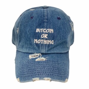 May include: A blue denim baseball cap with distressed detailing and the text "Bitcoin or Nothing" embroidered in white.
