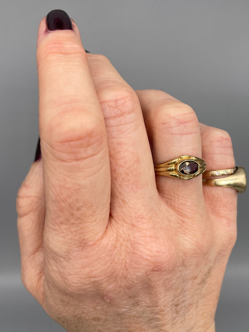 A lovely 9ct yellow gold vintage smokey topaz ring set with a single oval cut topaz in a lovely chunky gold band.