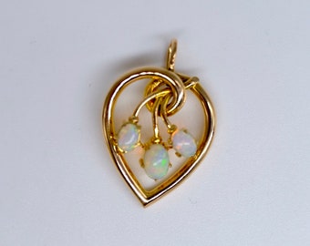 A fabulous antique opal heart pendant, three beautiful opals full of fire mounted in 15ct yellow gold, circa 1870