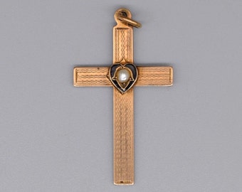 A rather cool antique engraved cross / crucifix pendant with a central black enamel heart motif set with a single white pearl, circa 1900