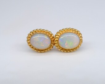 A lovely pair of opal ear studs set in pretty 9ct yellow gold rope decorated mounts,  circa 1980