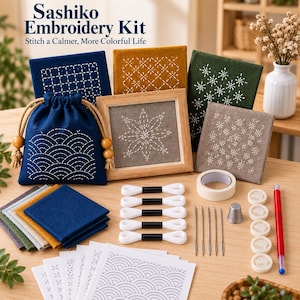 May include: A Sashiko Embroidery Kit featuring fabric squares with white geometric stitching, a blue drawstring pouch with wave patterns, a wooden frame, white embroidery thread, needles, a thimble, and pattern templates with the text Sashiko Embroidery Kit.