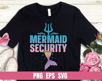 May include: Black t-shirt with a mermaid tail graphic and the text "Mermaid Security". The mermaid tail is blue, pink, and yellow. The text is in a blue, pink, and white gradient.