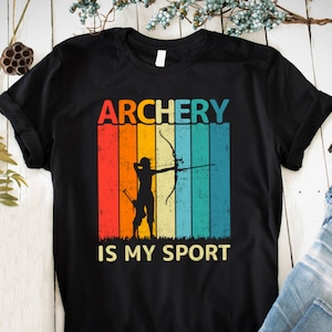 May include: Black t-shirt featuring a retro-style graphic of an archer with the text "ARCHERY IS MY SPORT".