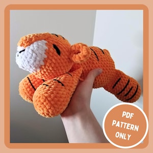 May include: Crocheted orange and white tiger plush toy with black stripes. PDF pattern only.