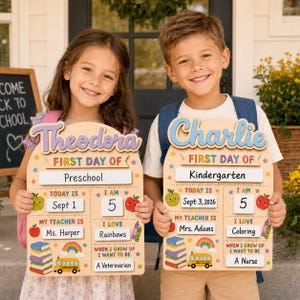May include: Two wooden first day of school signs with arched tops, featuring customisable white inserts for names, grades, dates, ages, teacher names, interests, and future goals, decorated with colourful illustrations of apples, books, and buses.