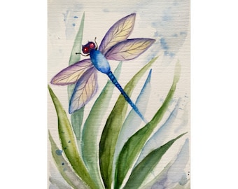May include: Watercolor painting of a blue dragonfly with red eyes, perched on green leaves against a light blue background.