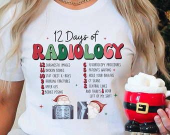 May include: White t-shirt with the text "12 Days of Radiology" in red and green. The shirt lists radiology-related items, including diagnostic images and CT scans. A Santa-themed mug is held in the image.