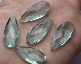 May include: Five teardrop-shaped, faceted, clear aqua blue gemstone pendants.