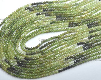 May include: A strand of green gemstone beads, faceted and with a slightly irregular shape. The beads are strung on a clear thread and are approximately 3mm in diameter.
