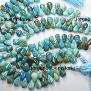 May include: A strand of blue, green, and brown teardrop-shaped opal beads. The beads are strung on a cord and have a natural, irregular shape. The beads are approximately 10mm in size. GorgeousGemstone is printed on the image.