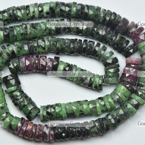 May include: A strand of green and pink faceted gemstone beads. The beads are round and have a faceted finish. The beads are strung on a string and are ready to be used for jewellery making.