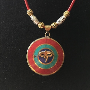 Tibetan style pendant with Buddhist motifs