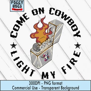 May include: A silver lighter with a floral bull skull design, flames, and the text "COME ON COWBOY LIGHT MY FIRE." The design includes stars and is set against a white wood grain background.