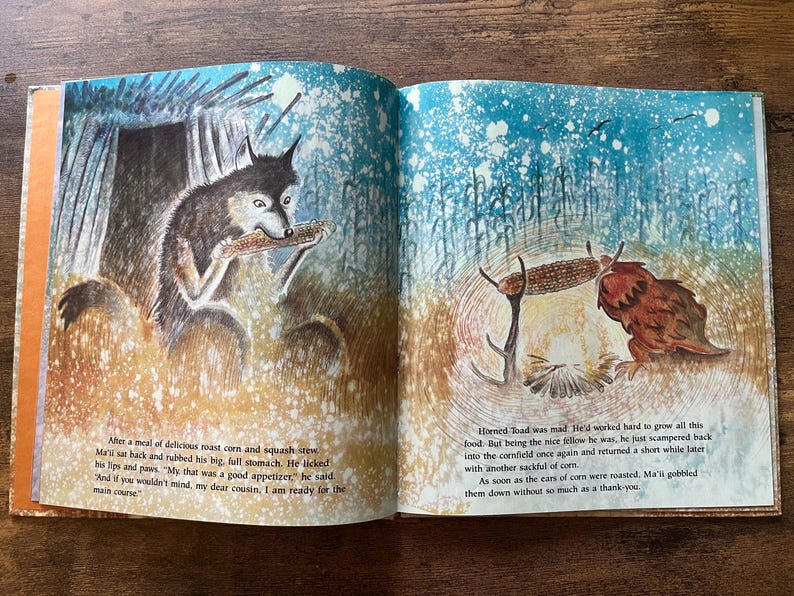 May include: An open children's storybook featuring two pages of illustrations. The left page shows a wolf eating corn near a shelter. The right page depicts a horned toad near a cornfield. Both pages contain printed text in English.