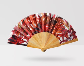May include: A red and white hand fan with a floral design. The fan is made of paper and has a wooden handle.