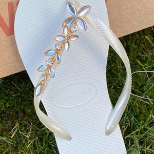 May include: A rustic wooden sign with the text "Welcome to our home" in white lettering. The sign has a distressed finish and a simple, inviting design, suitable for a front porch or entryway.