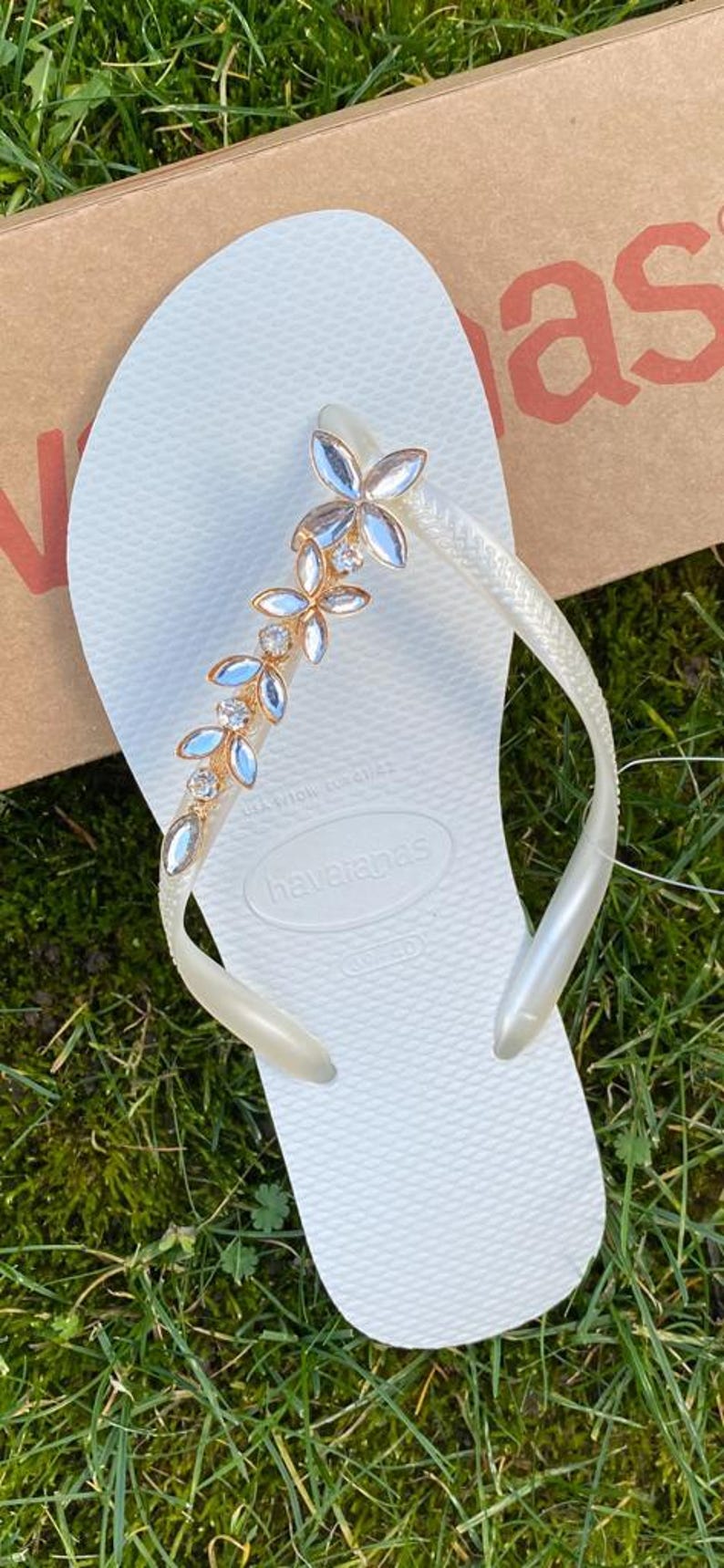 May include: A rustic wooden sign with the text "Welcome to our home" in white lettering. The sign has a distressed finish and a simple, inviting design, suitable for a front porch or entryway.