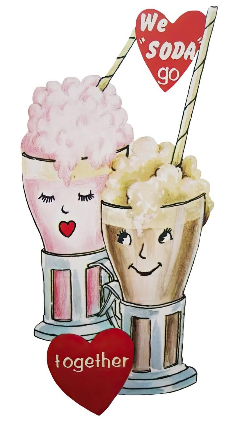 May include: A charming illustration of two soda drinks with faces, each in a glass with a handle. One is pink, the other brown, both topped with foam and straws. A red heart with the words "We soda go" and another with "together" complete the design.